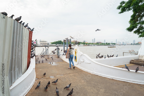 Photography Attractive woman walking to Tha Chang - Wat Rakhang Pier in Bangkok Noi