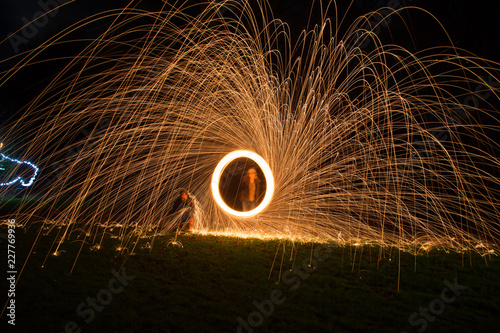 sparks fly from a circular spin in a long shutter