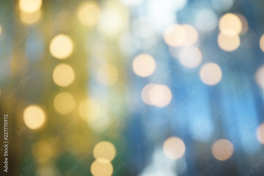 Bokeh from indoor lighting,  Colorful light circles spread on blue with yellow and green background for the celebration of the holiday season