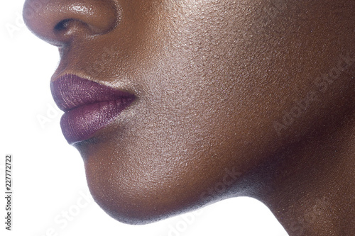 Lips of young beautiful black woman with clean perfect skin