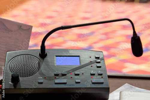 Translator room . translators cubicle . interpreting - Microphone and switchboard in an simultaneous interpreter booth . Soft focus of wireless Conference microphones and notebook in a meeting room.