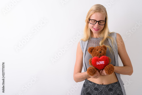 Beautiful blond woman standing against white background