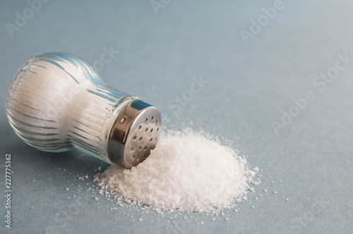  A pile of salt from salt shaker, concept excessive salt intake 