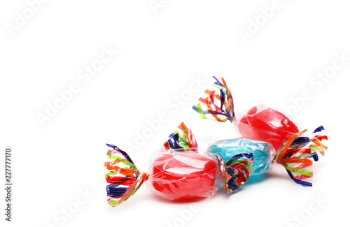Colorful candies with transparent cellophane wrapping isolated on white background 