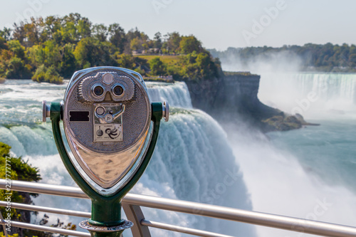 Tourist telescope with view on Niagara Falls from the USA