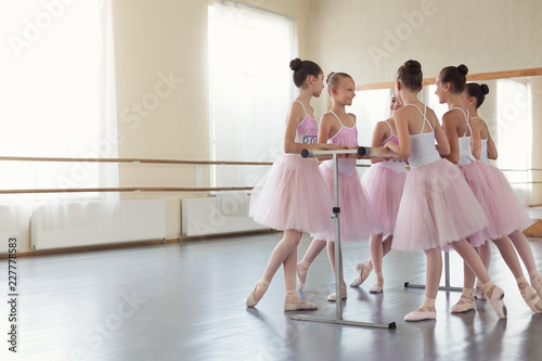 Little ballerinas having break in practice, copy space
