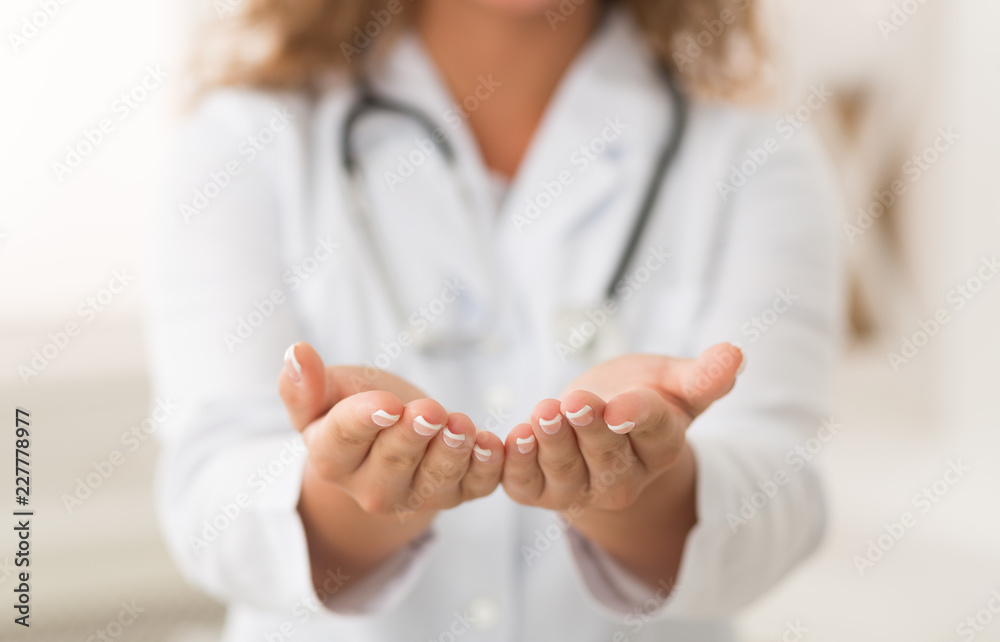 Female doctor holding something in hands, copy space Female doctor holding something in hands, copy space