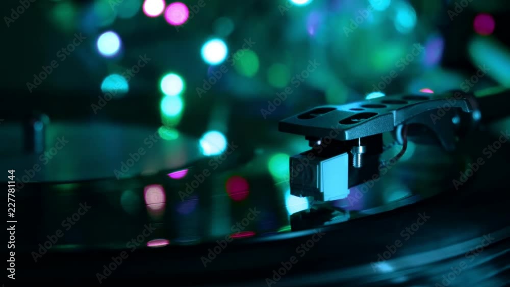 Vinyl record player. Needle drops. Night cold neon lights background. Vinyl record player. Needle drops. Night cold neon lights background.