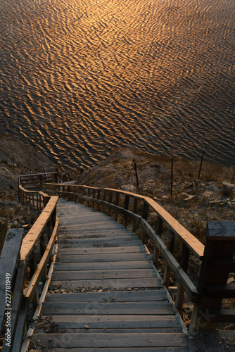 steep descent to the sea. wooden steps. sunset