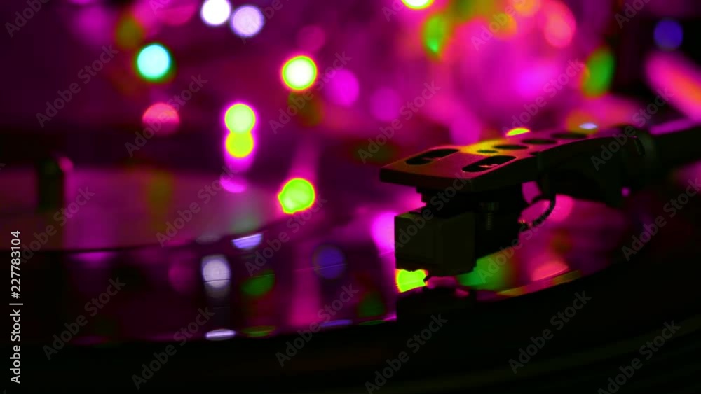 Vinyl recrod played spinning disc. Atmosphere cyan light on a background.