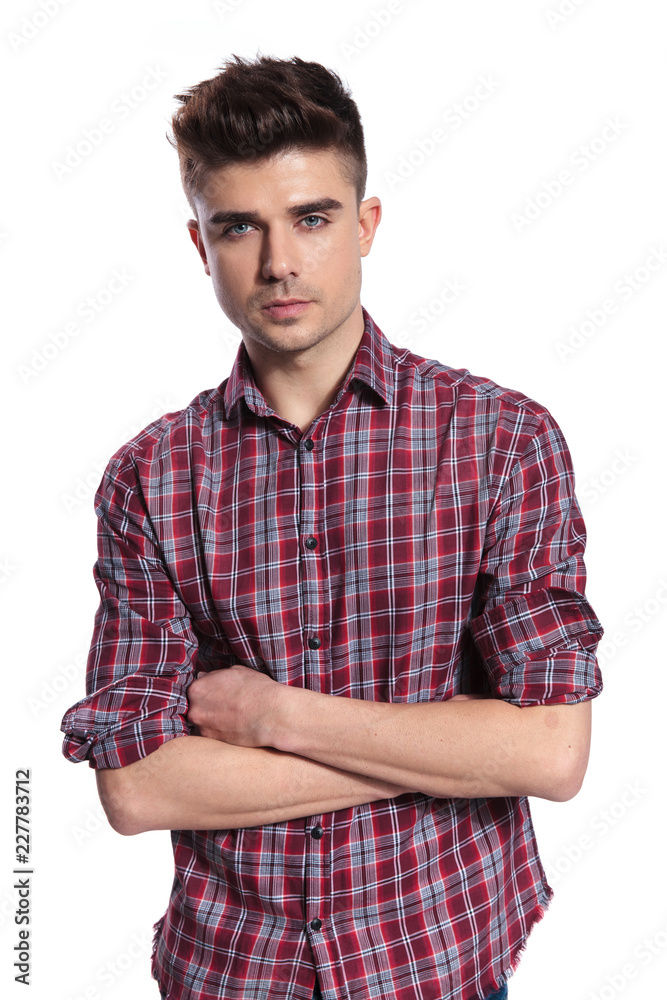 portrait of handsome casual man standing with arms folded portrait of handsome casual man standing with arms folded