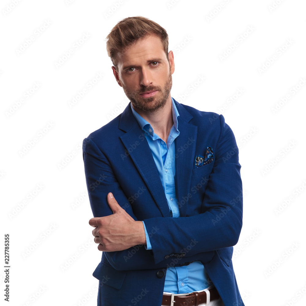 confident smart casual man standing with hands crossed confident smart casual man standing with hands crossed