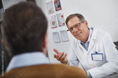 I am sure everything will be fine. Doctor kindly talking with male in his office