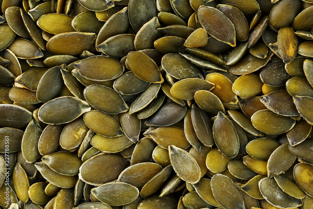 Macro background texture of green pumpkin seeds Macro background texture of green pumpkin seeds