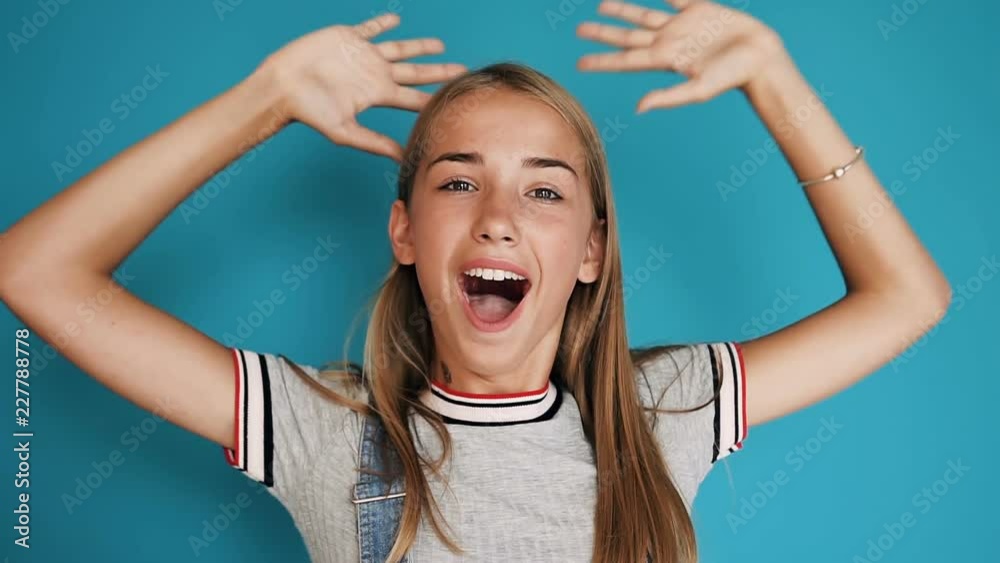 Portrait of a beautiful teen girl who expresses different emotions of happiness, surprise, shock. Face of a girl with big brown eyes and long hair. Happy schoolgirl or student