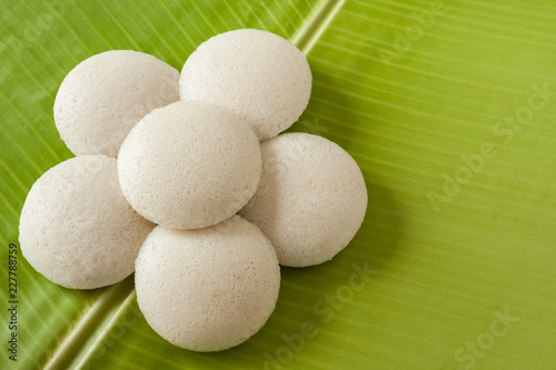 Indian idly served as a flower - Fresh steamed Indian Idly (Idli / rice cake) arranged decoratively as a flower on traditional banana leaf. Natural light used.