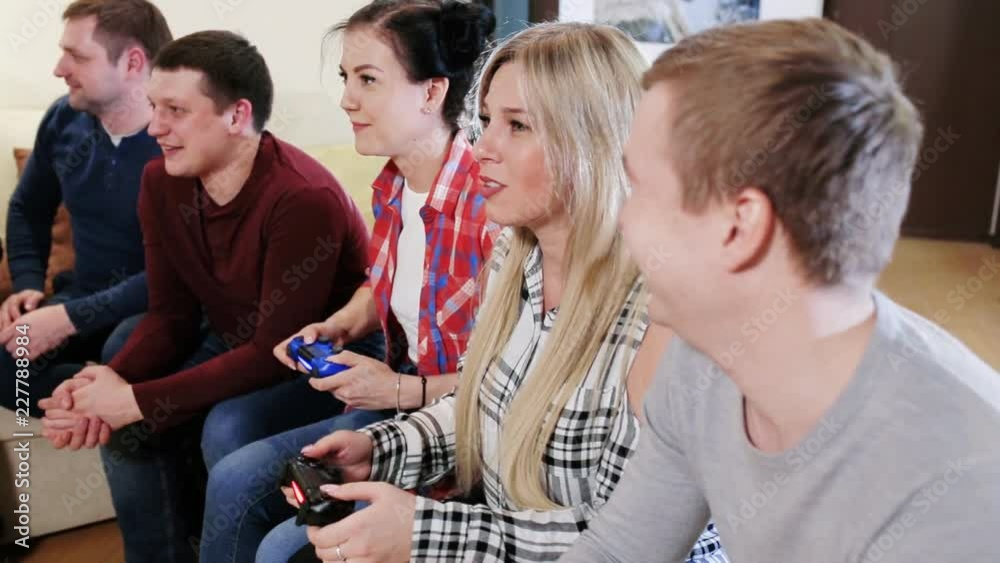 Group of friends sitting on the couch and gaming