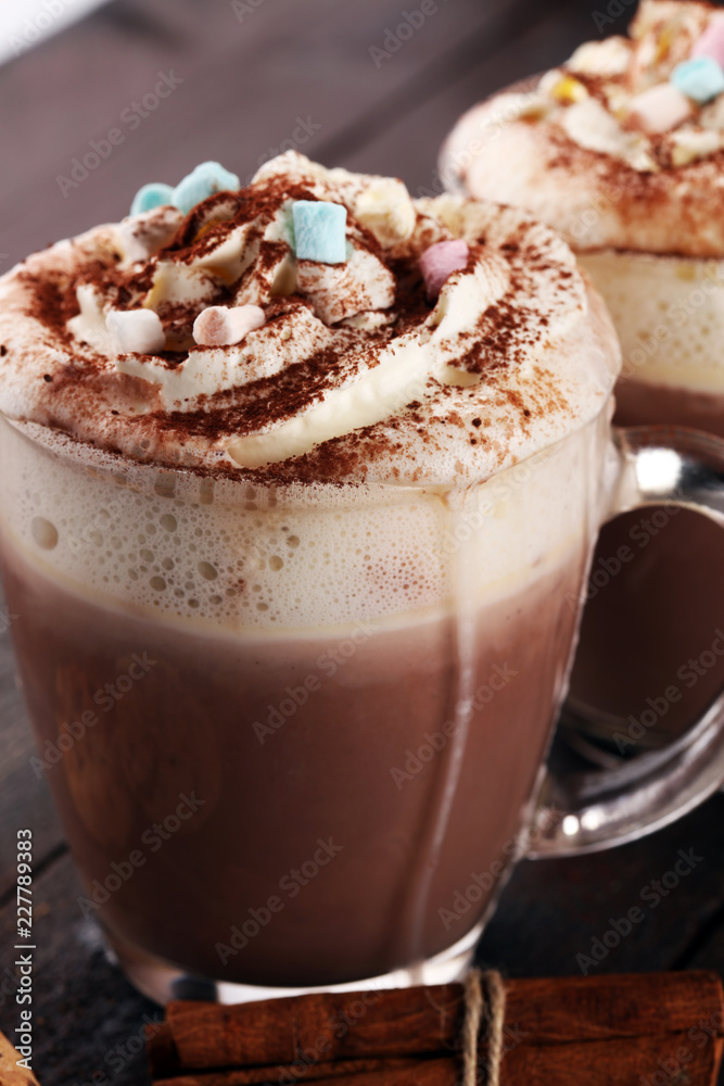 Hot chocolate cocoa with whipped cream on table.