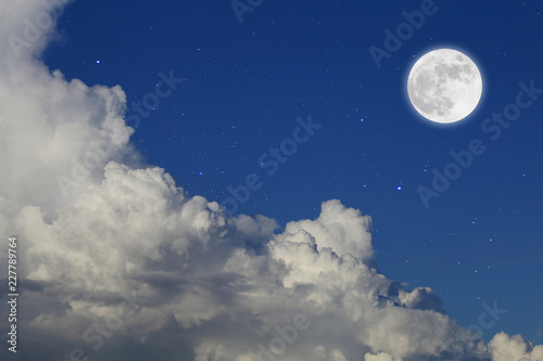 Romantic night. Full moon over cloudscape background.