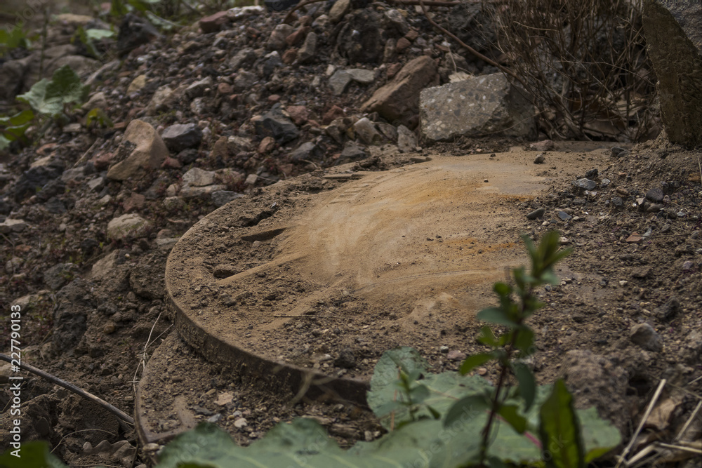 Obraz premium Old sewer cover with dirt