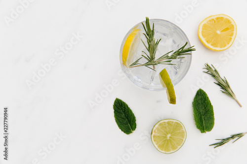 Gin tonic cocktail drink with green lime white background