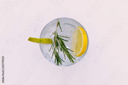 Gin tonic cocktail drink with green lime top view white background
