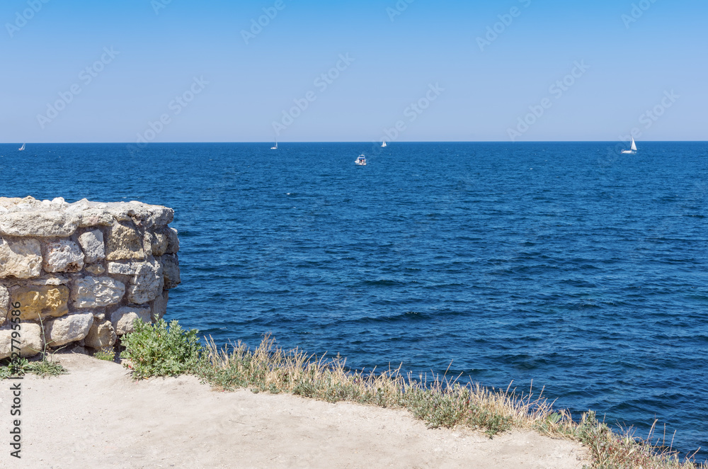 View of the Black Sea from the Crimean coast. Russia, the Republic of Crimea, the city of Sevastopol. 11.06.2018: The ruins of the ancient and medieval city of Chersonese Tauride