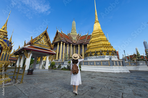 Woman tourist is enjoy traveling inside Wat Phra Keaw in Bangkok, Thailand.