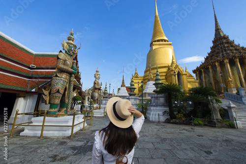 Woman tourist is enjoy traveling inside Wat Phra Keaw in Bangkok, Thailand. photo