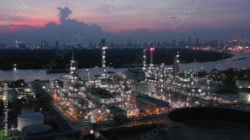 Video Industrial view at oil refinery plant form industry zone with sunrise and cloudy sky.Oil refinery and Petrochemical plant at dusk,Thailand. Aerial view