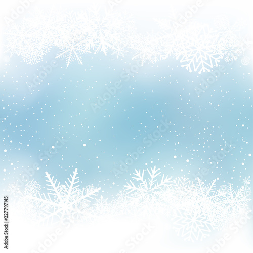 Winter blue sky background with snow frame. Frosty close-up wintry snowflakes. Ice shape pattern template. Christmas holiday decoration backdrop