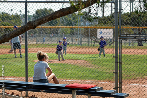 Canvas Print Girl on the bleachers watching little boys play t-ball.
