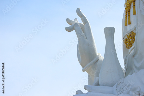 Canvas Print Hand of Thai famous big white bodhisattva guanyin statue with copy space sky background at Wat Huai Pla Kung temple, Chiang rai