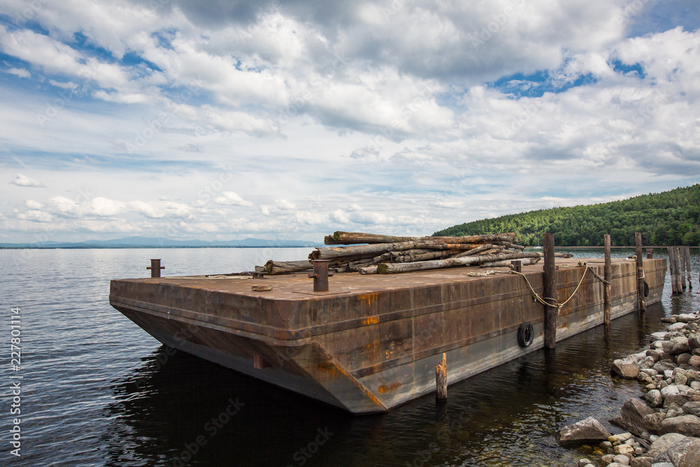 Barge  carrying wood logs