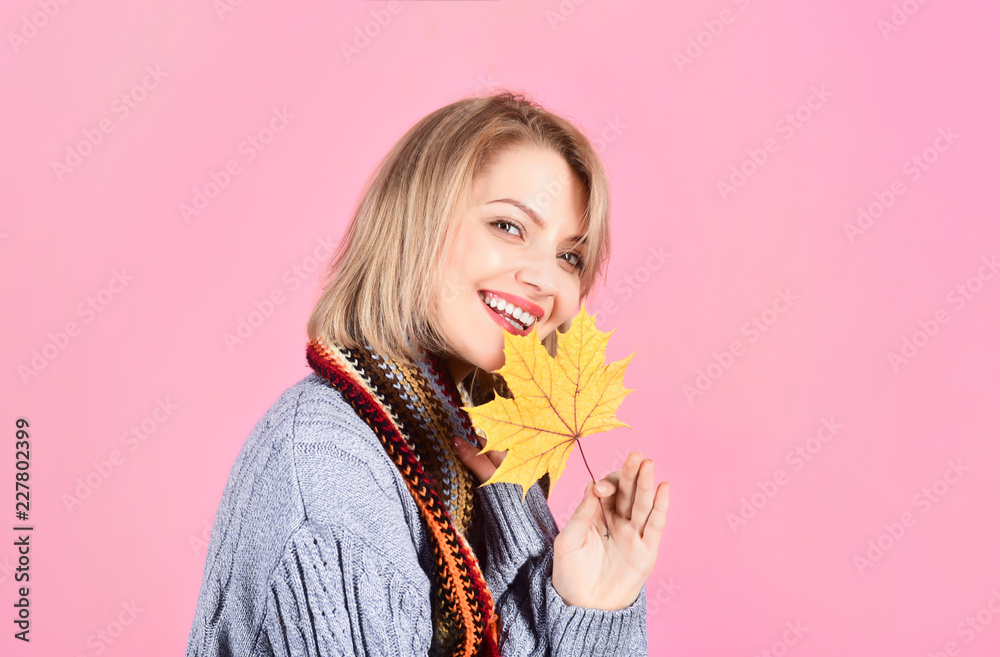 Autumn. Smiling woman holds yellow maple leaf. Woman with autumnal leaf. Yellow maple leaf. Woman holds leaf. Isolated. Autumn mood. Autumn leaves. Warm clothes. Autumn. Smiling woman holds yellow maple leaf. Woman with autumnal leaf. Yellow maple leaf. Woman holds leaf. Isolated. Autumn mood. Autumn leaves. Warm clothes.