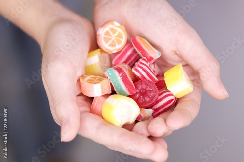 Colorful sweets in hands photo