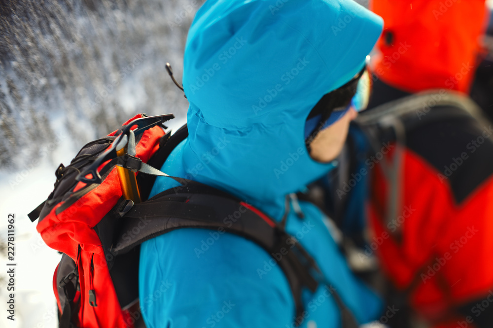Ice ax strapped on a backpack climber closeup. Tilt-shift effect. Ice ax strapped on a backpack climber closeup. Tilt-shift effect.