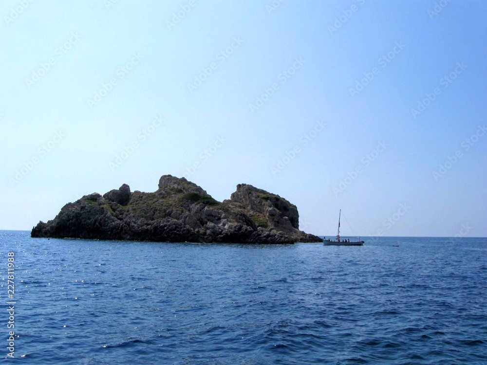 boat near small rocky island