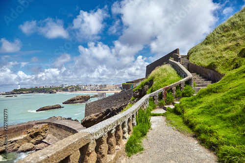 Biarritz city. Old stone staircase with balusters on the hillside. Seascape. Bay of Biscay, Atlantic coast, France. Summer day with blue sky and white clouds