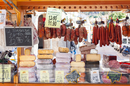 Traditional Majorcan Sobrassada saussage and Mahon cheese for sale at a local market in Esporles, Mallorca, Spain photo