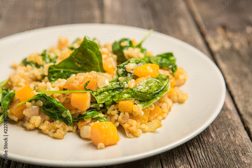 Vegan plate with bulgur and pumpkin. Vegan plate with bulgur and pumpkin.