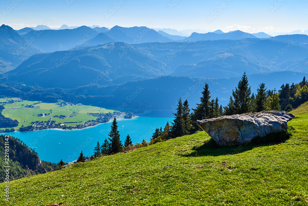 Mountain landscape with forest, lake and blue sky in Austrian Alps. Salzkammergut region