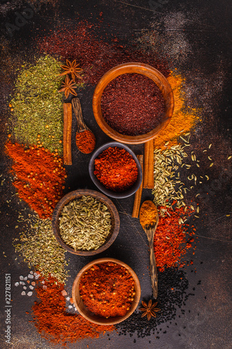 Different kind of spices on dark background.