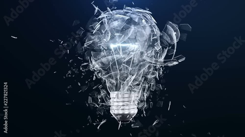 Explosion of an incandescent lamp or ligh bulb. Small pieces of glass fly apart in different directions. The effect of slowing down the time after the explosion. Problem solving concept. photo