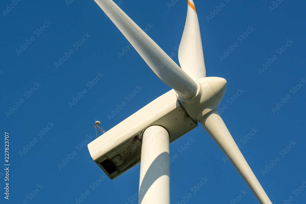 Wind turbine against blue sky. Wind energy. Eco concept. Wind turbine against blue sky. Wind energy. Eco concept.