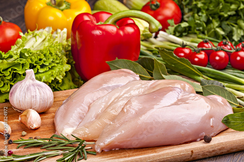 Fresh chicken meat for cooking with vegetables, spices and herbs.
