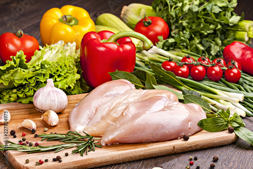 Fresh chicken meat for cooking  with vegetables, spices and herbs.