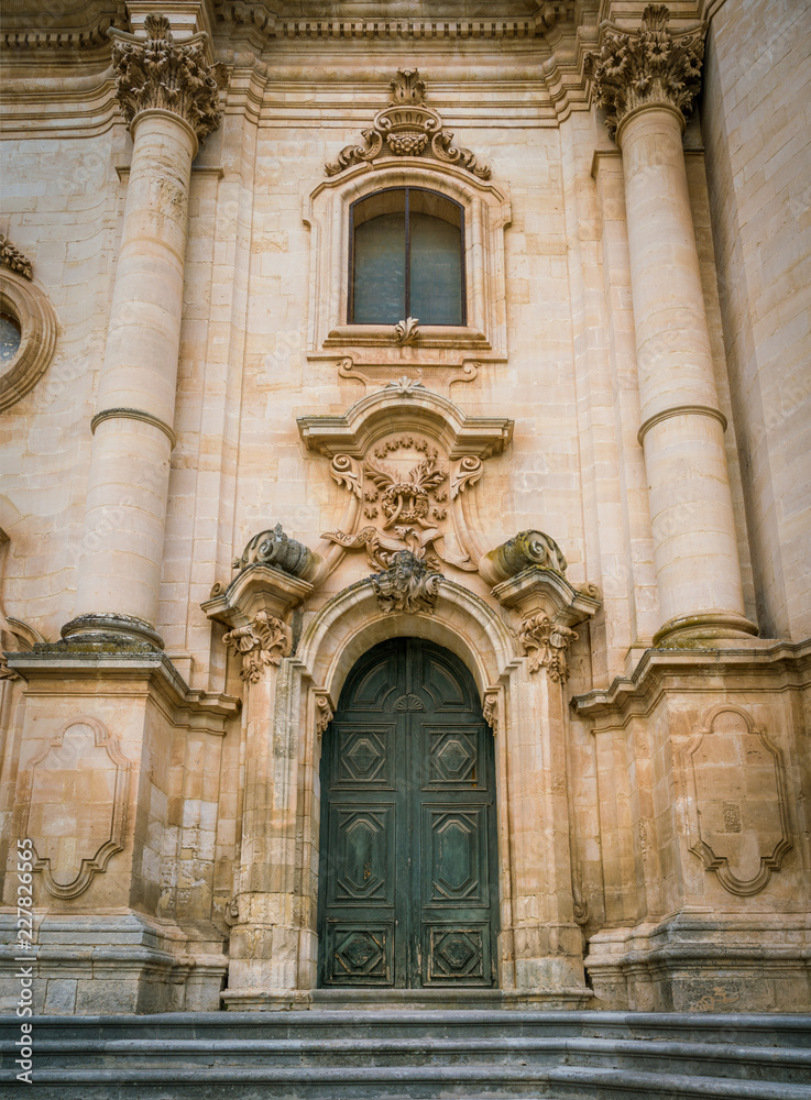 Ornate door to the Duomo of San Giorgio in Modica, fine example of sicilian baroque art. Sicily, southern Italy.