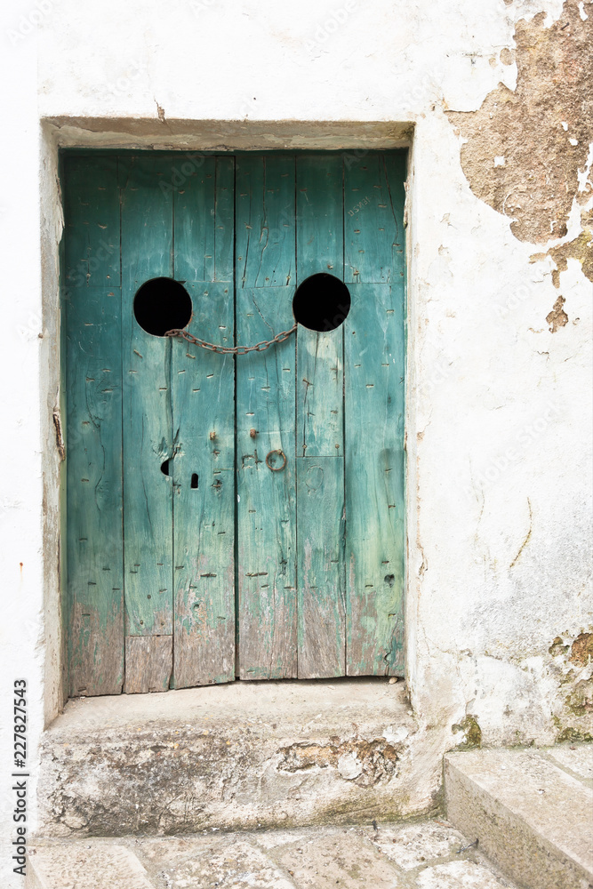 Specchia, Apulia - An old wooden door tightened with a steel track Specchia, Apulia - An old wooden door tightened with a steel track