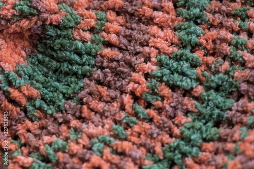 Striped  brown, green and orange knit fabric texture, knitted pattern background © lusyaya